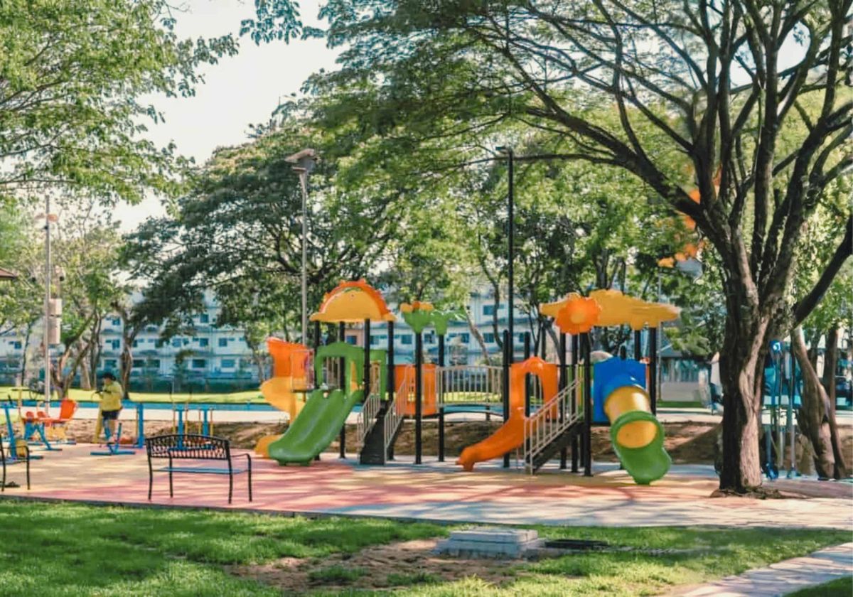 Colorful children's playground with slides in a shady Chiang Mai park