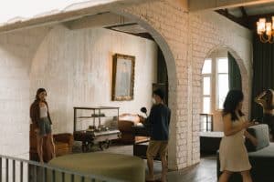 Spacious whitewashed-brick interior with archways and vintage furniture at Graph Contemporary