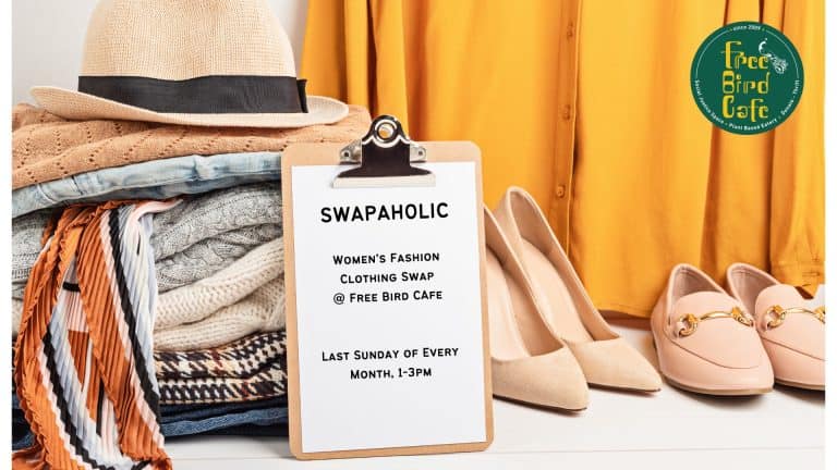 Free Bird Cafe SWAPAHOLIC women's clothing swap flyer beside folded clothes and shoes, held the last Sunday monthly 1-3pm