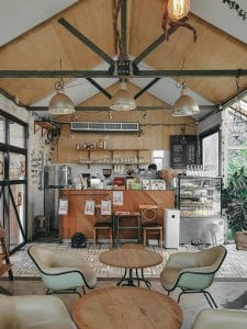 Boho greenhouse cafe with a vaulted timber ceiling and coffee counter at The Barn Eatery and Design