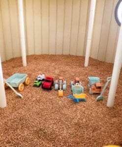 Kinetic sand play station with toy trucks, diggers and wheelbarrows at Little Soul Kids Planet