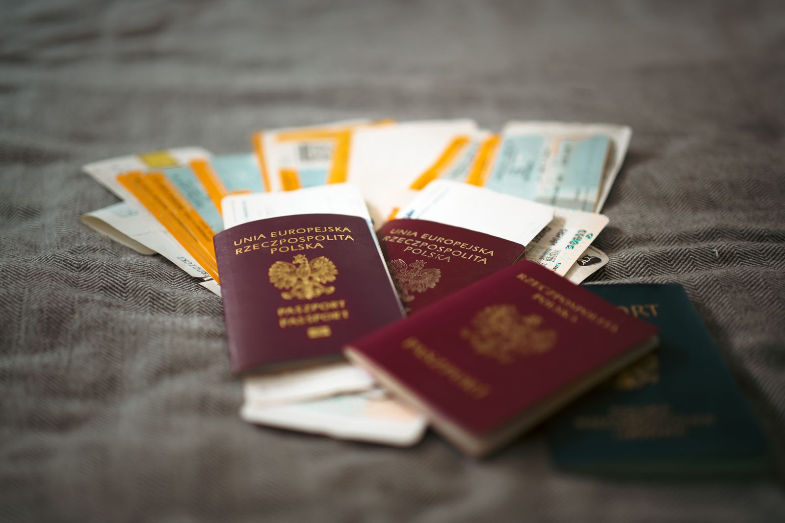 A passport and travel documents spread on a table
