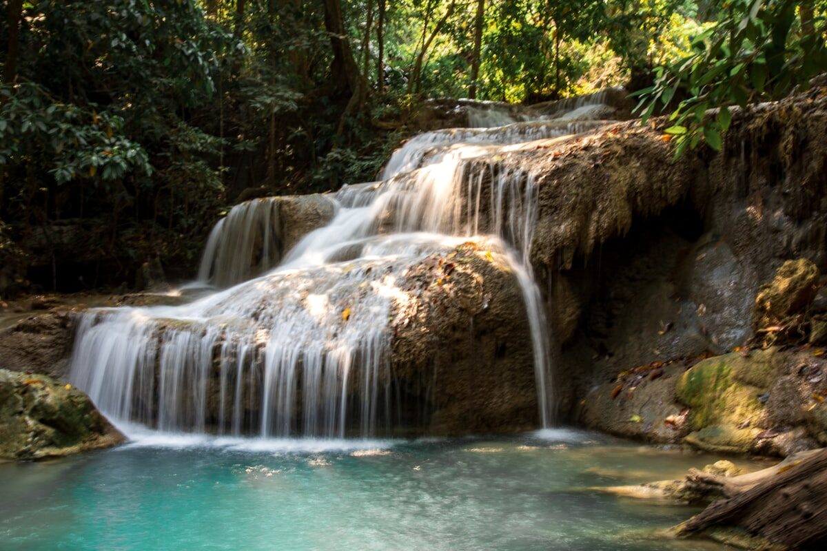 Jungle waterfall cascading over rock terraces into a turquoise pool